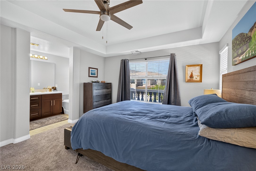 226 Priority Point Street Henderson, NV 89012 - Photo 4 of 32 An elegant tray ceiling and soft carpeting define this inviting primary suite.