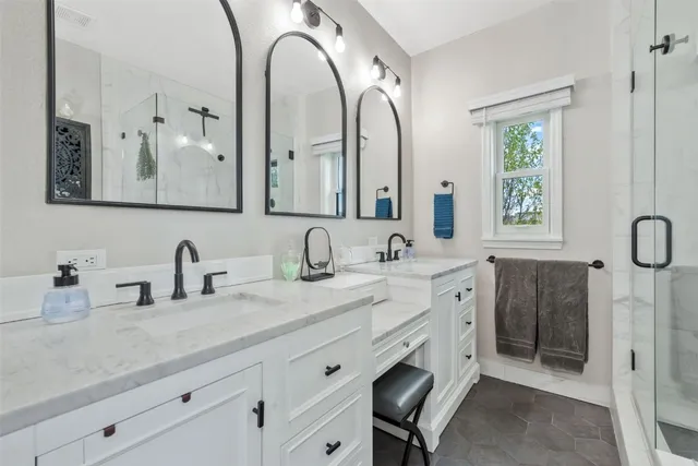 a bathroom with a double vanity sink mirror and double