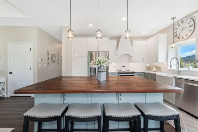 a view of a kitchen with a table and chairs