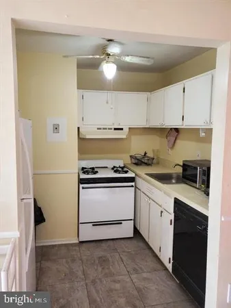 a kitchen with a sink cabinets and appliances