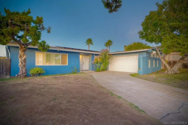 a view of a house with a yard and garage