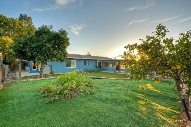 a front view of a house with a garden