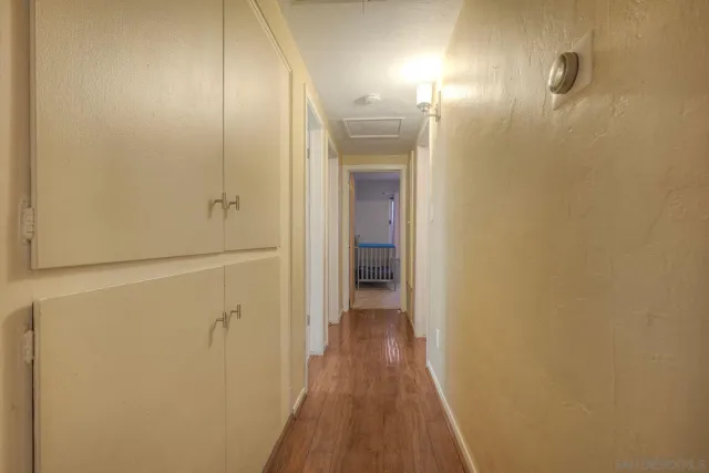 a view of a hallway with wooden floor