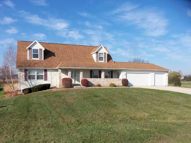 6738 Friday Road Byron, IL 61010 - Photo 1 of 25 a front view of a house with a garden