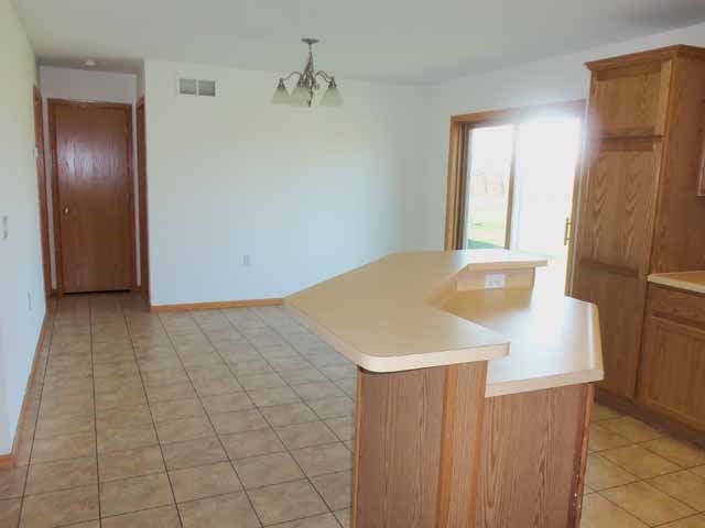 6738 Friday Road Byron, IL 61010 - Photo 11 of 25 a view of kitchen with furniture and wooden floor