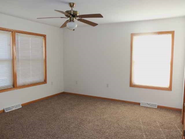 6738 Friday Road Byron, IL 61010 - Photo 15 of 25 an empty room with a window and a fan