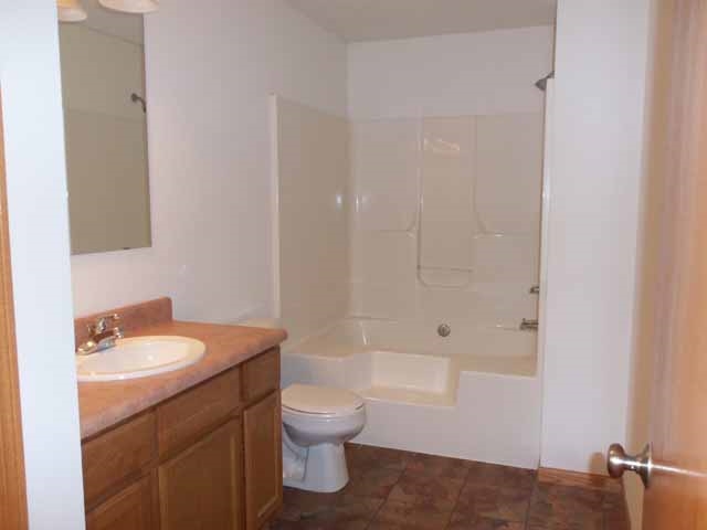 6738 Friday Road Byron, IL 61010 - Photo 17 of 25 a bathroom with a sink toilet and shower