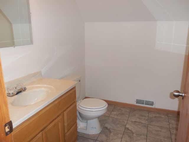 6738 Friday Road Byron, IL 61010 - Photo 21 of 25 a bathroom with a granite countertop toilet and a sink