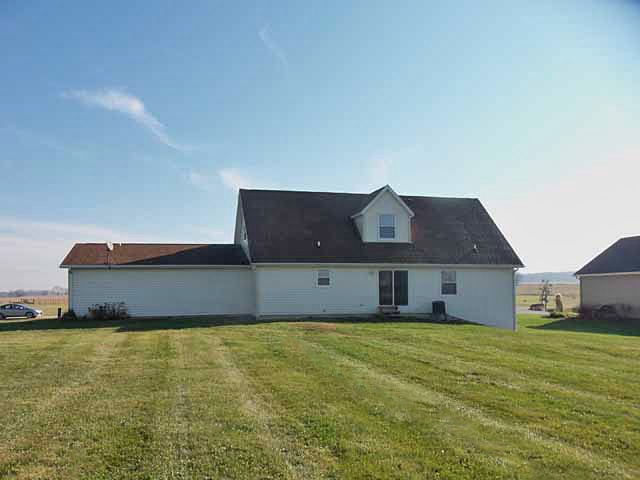6738 Friday Road Byron, IL 61010 - Photo 4 of 25 a front view of a house with a yard