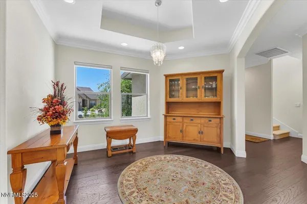 a very nice looking living room with a large window and dining table
