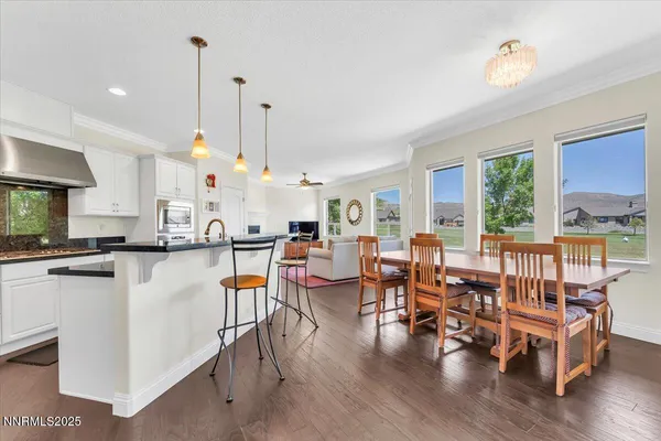 a large kitchen with cabinets table and chairs
