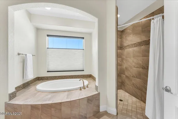 a bedroom with a bed and a ceiling fan