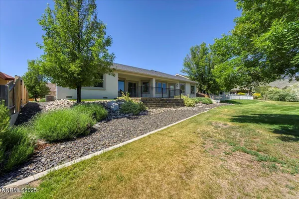 an aerial view of a house with a garden and lake view