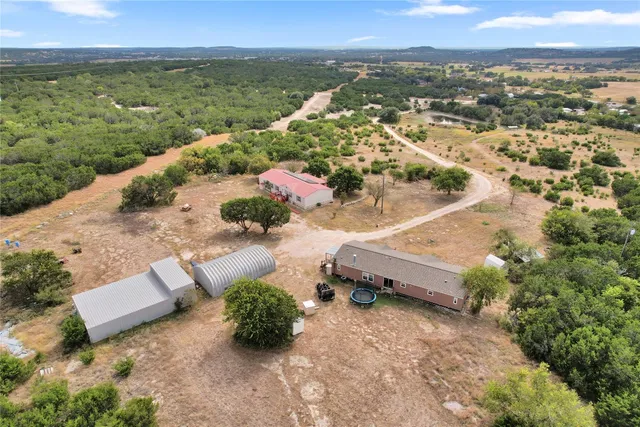 an aerial view of a house with a yard