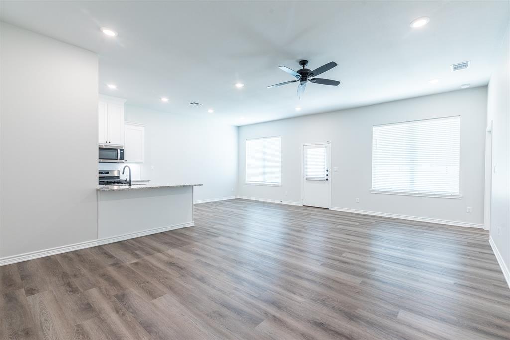 14151 County Road 192 Tyler, TX 75703 - Photo 14 of 28 an empty room with wooden floor and windows