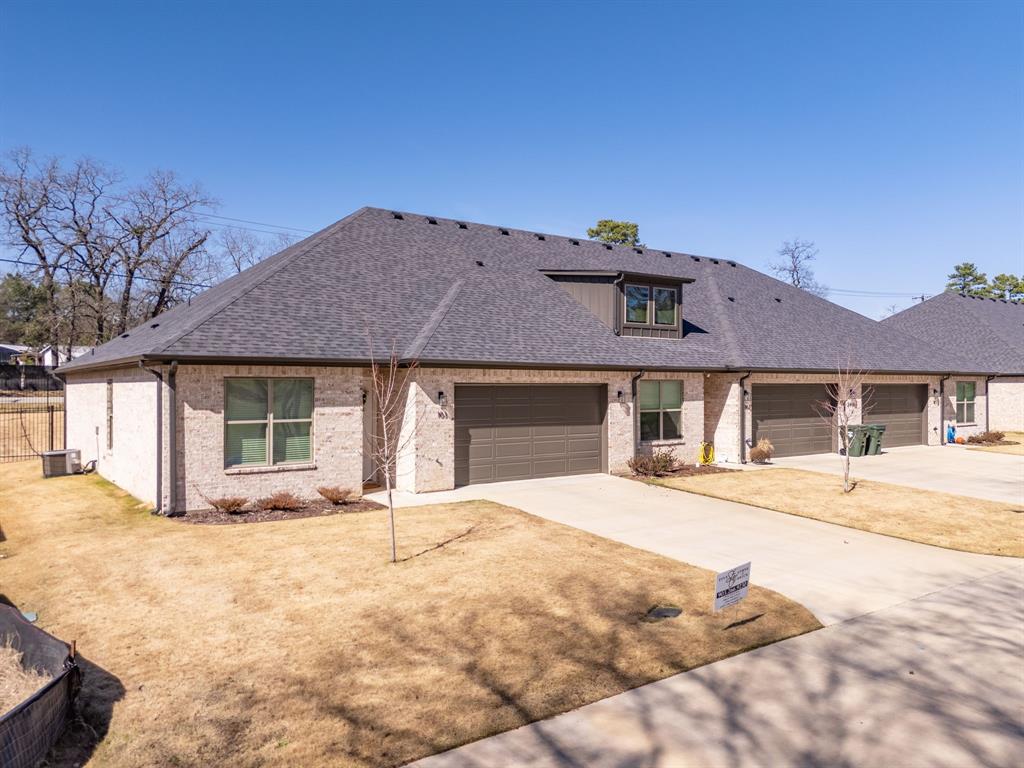 14151 County Road 192 Tyler, TX 75703 - Photo 2 of 28 a front view of a house with a yard and garage