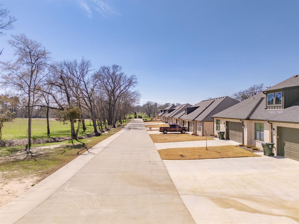 14151 County Road 192 Tyler, TX 75703 - Photo 10 of 28 a view of house with yard and trees in the background