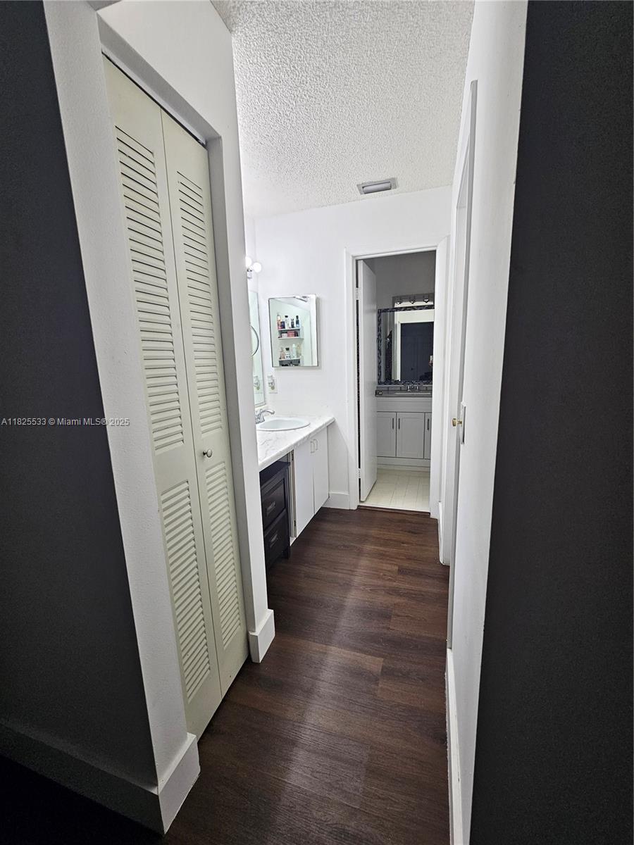 1002 Adams Avenue, Unit 1002E Homestead, FL 33034 - Photo 11 of 13 workspace with wooden floor and stairs