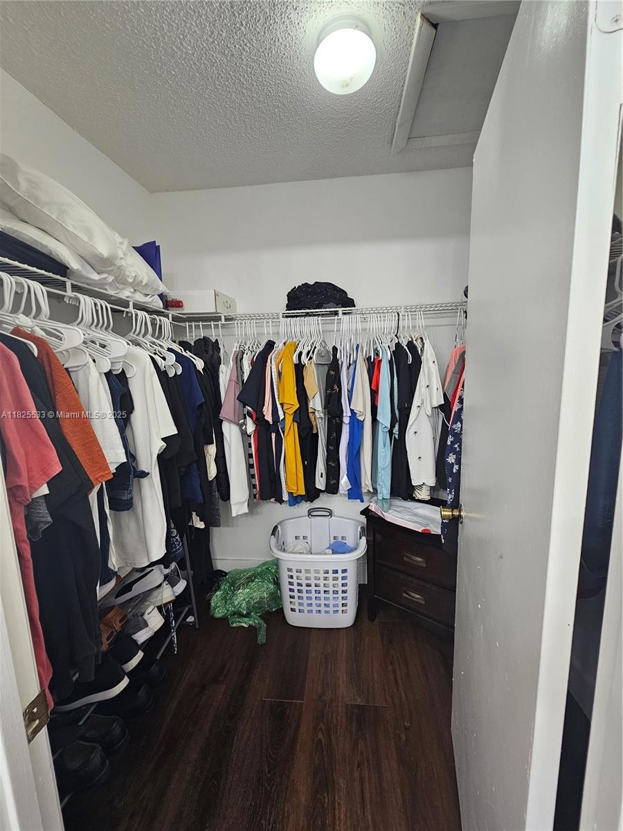 1002 Adams Avenue, Unit 1002E Homestead, FL 33034 - Photo 13 of 13 a view of walk in closet with clothes