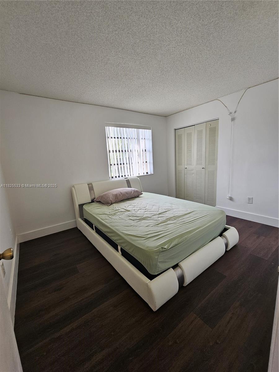 1002 Adams Avenue, Unit 1002E Homestead, FL 33034 - Photo 4 of 13 a bedroom with a bed and window