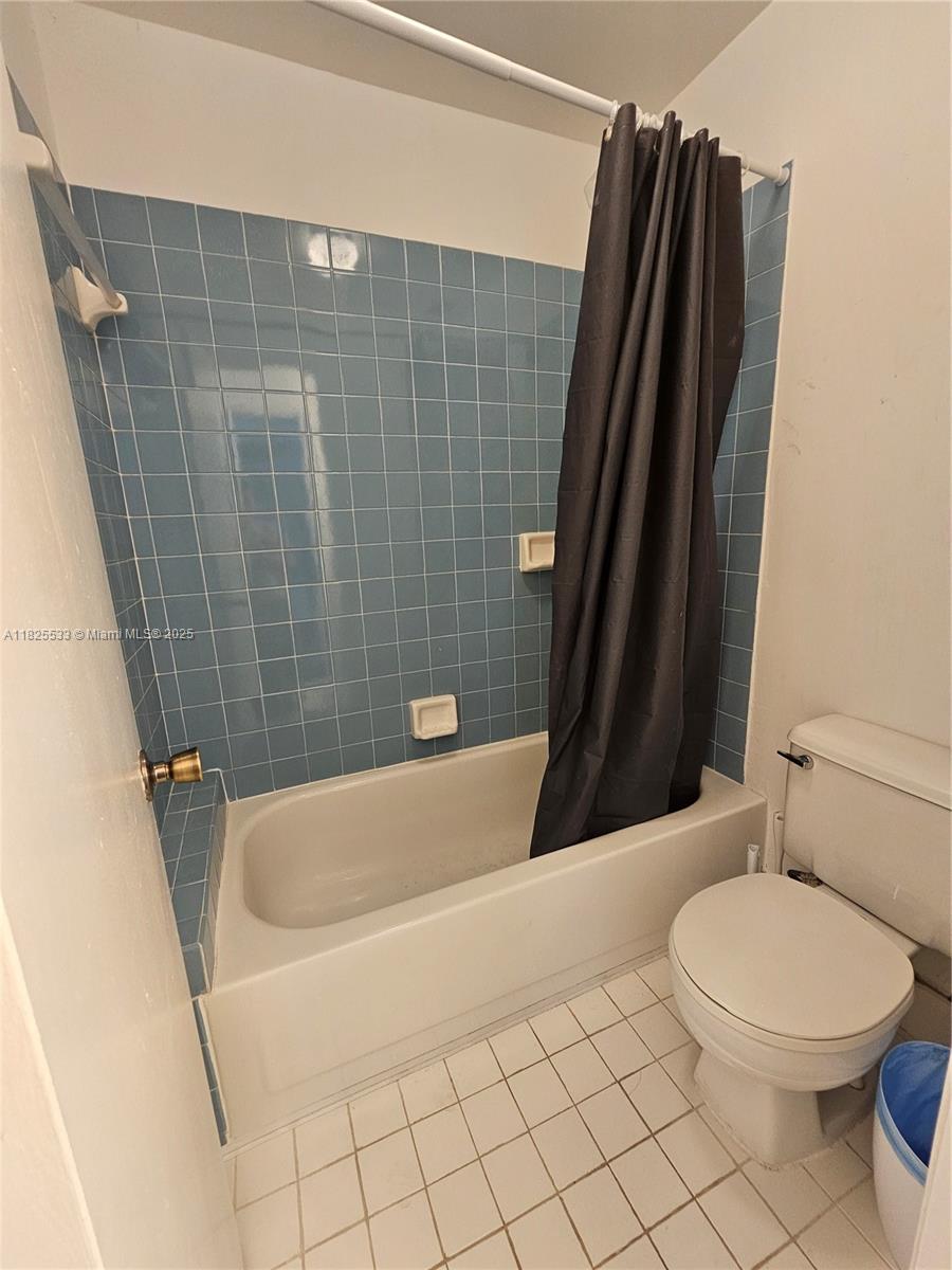 1002 Adams Avenue, Unit 1002E Homestead, FL 33034 - Photo 7 of 13 a bathroom with a sink a toilet and shower