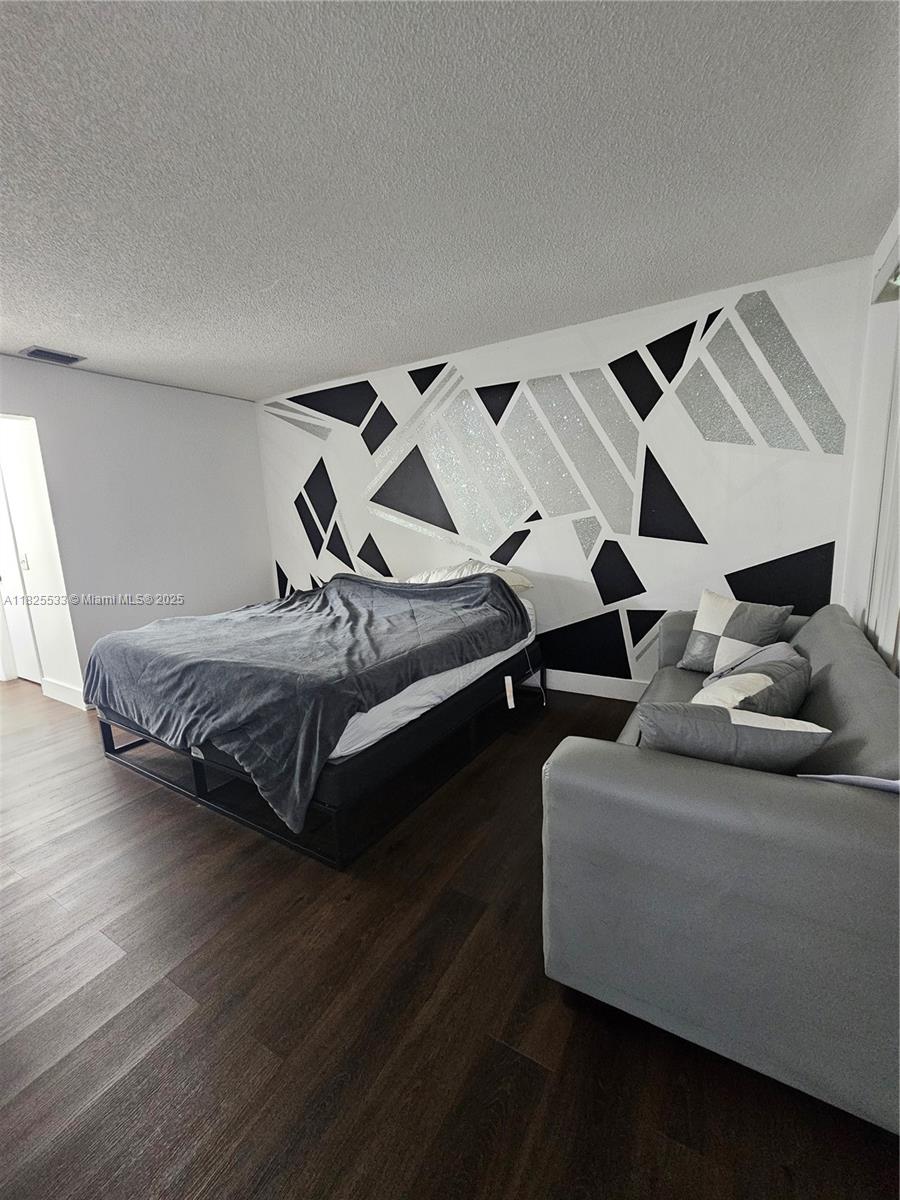 1002 Adams Avenue, Unit 1002E Homestead, FL 33034 - Photo 10 of 13 a bedroom with furniture and a couch