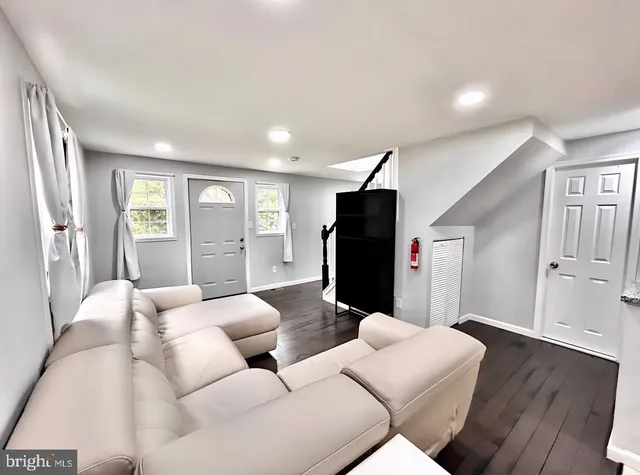 a living room with furniture window and wooden floor