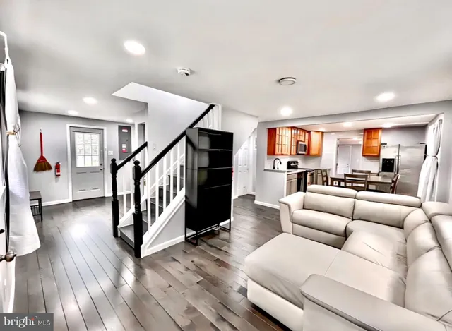 a living room with furniture and wooden floor