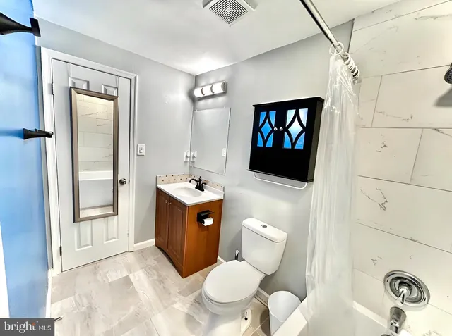 a bathroom with a sink toilet and shower