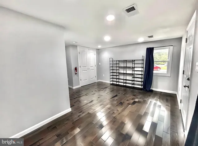 wooden floor in an empty room with a fireplace