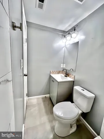 a bathroom with a toilet sink and shower