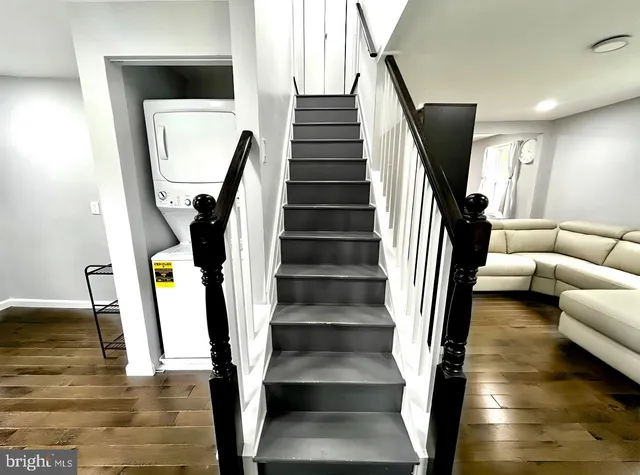 a view of entryway and hall with wooden floor