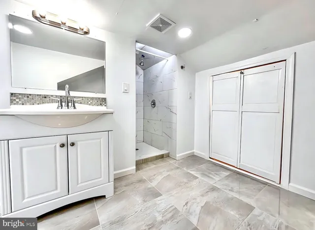 a view of a bathroom with a sink and mirror