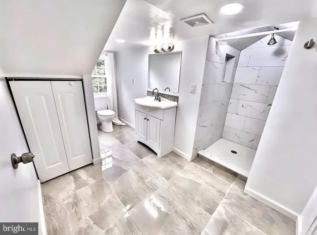 a bathroom with a double vanity sink and mirror