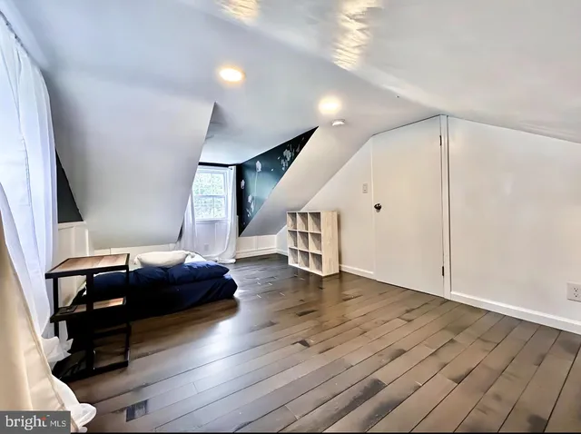 a living room with wooden floor and furniture
