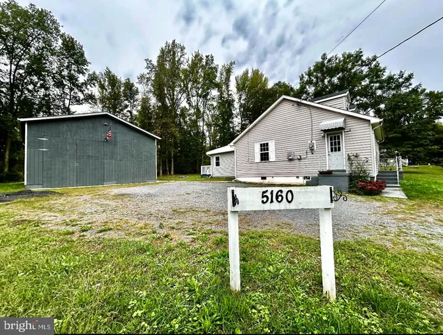 a view of a house with a yard and garage