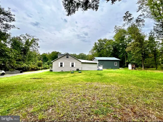 a view of a big yard with a house