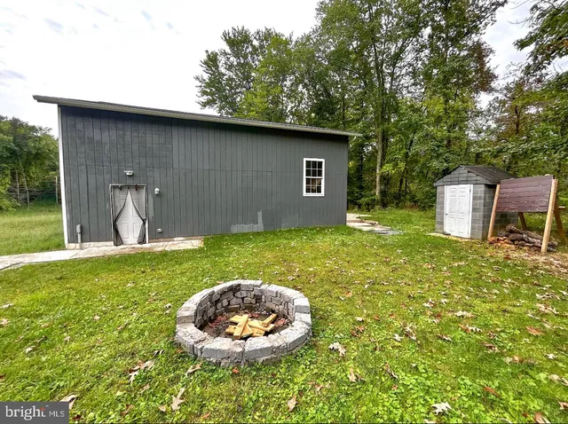 a backyard of a house with table and chairs