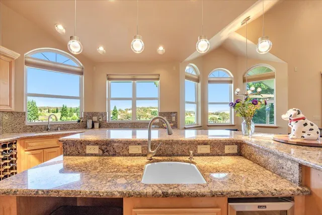 a view of a patio with a table chairs and a fire pit