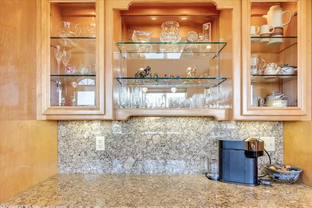 a view of a two chairs in the patio in front of a house