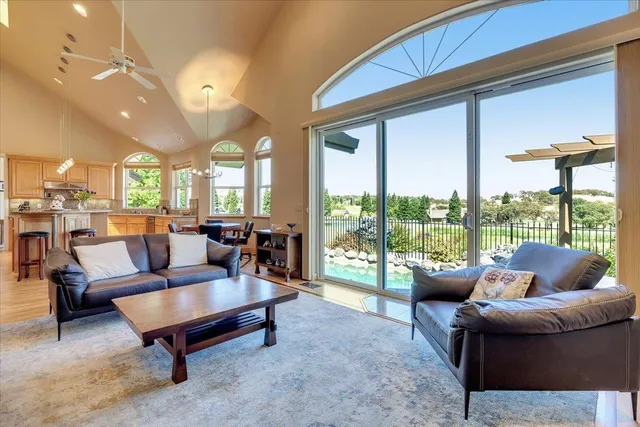 a spacious bedroom with a bed and a flat screen tv