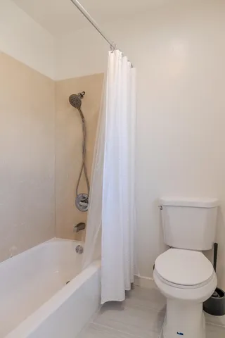 a bathroom with a toilet and a bathtub