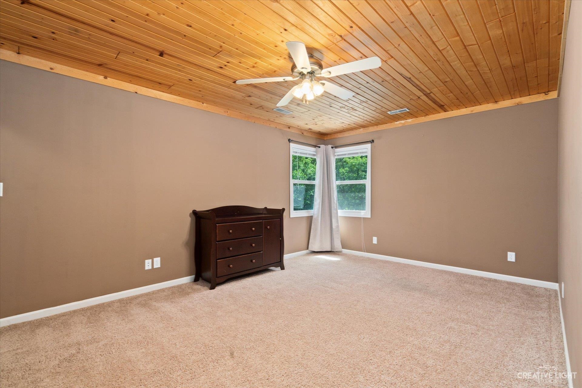 7226 South Lost Nation Road Dixon, IL 61021 - Photo 18 of 36 en empty room with windows and ceiling fan