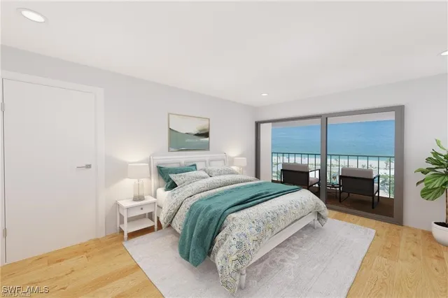 a bedroom with a bed and a large window