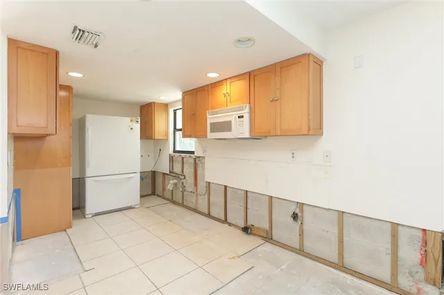a kitchen with stainless steel appliances a refrigerator and cabinets