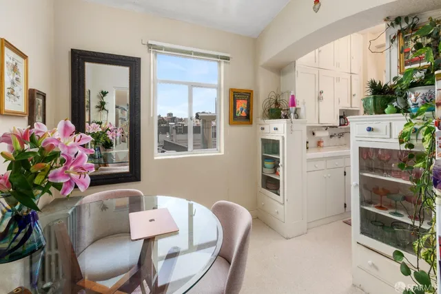 a dining room with furniture and flowers