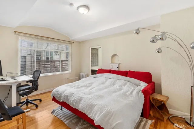 a bed sitting in a bedroom next to a window