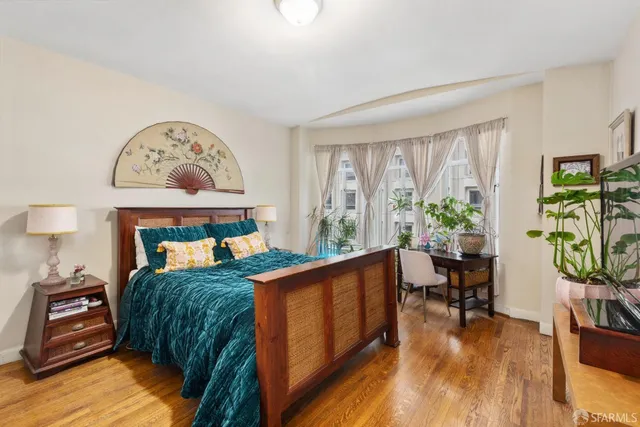 a bedroom with furniture and a large window