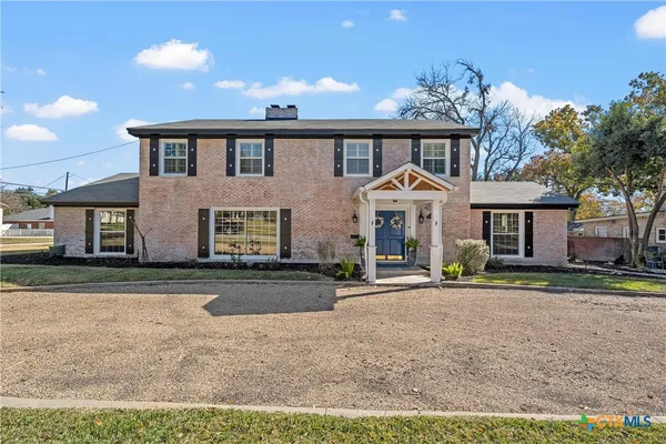 a front view of a house with a yard and a garage
