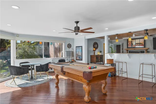 a living room with fireplace furniture and a wooden floor